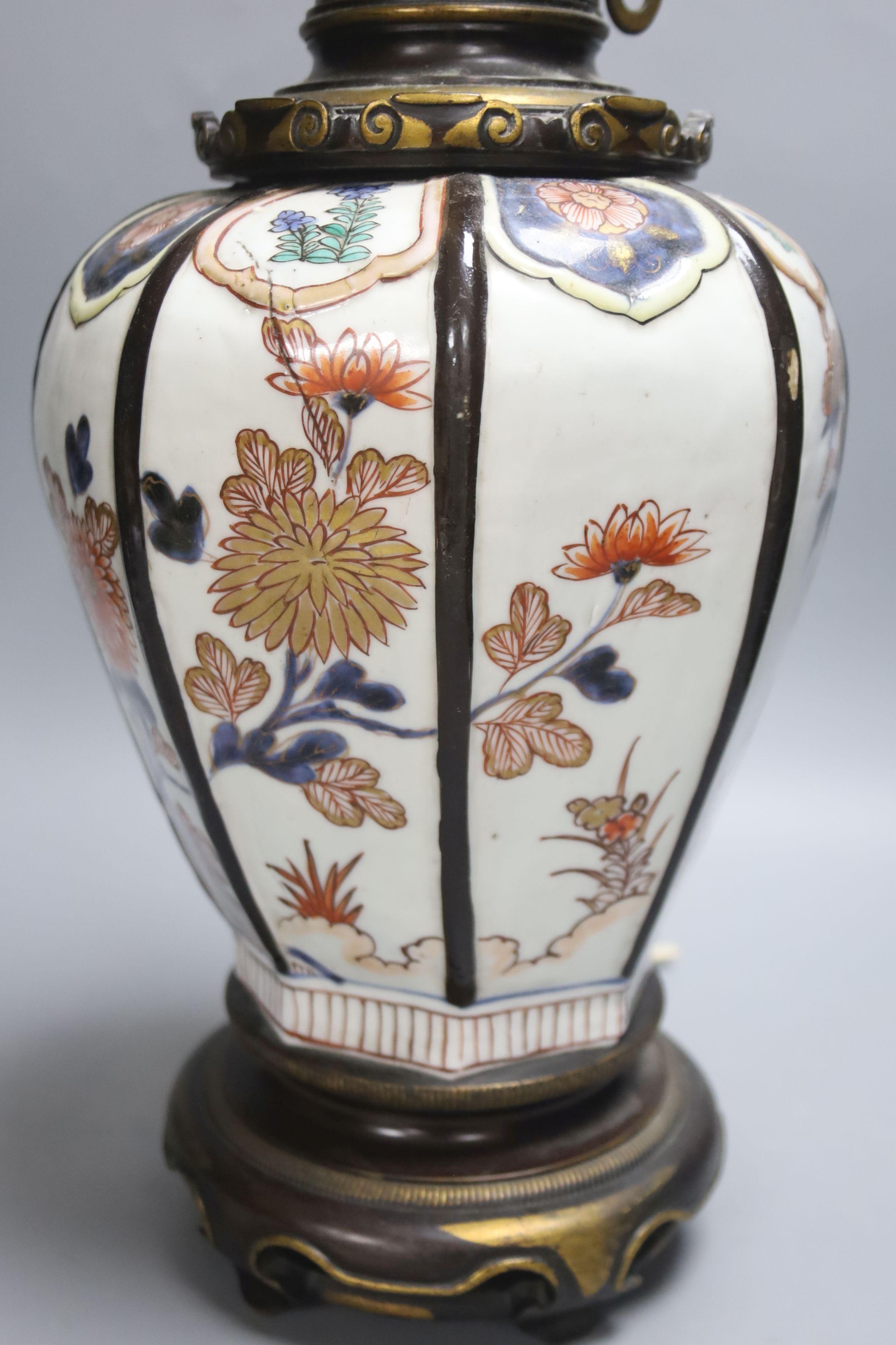 A Japanese Imari table lamp, of hexagonal form with gilt bronze fittings (formerly an oil lamp)